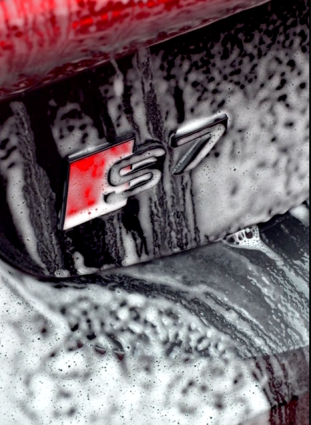 Audi S7 badge covered in wash foam