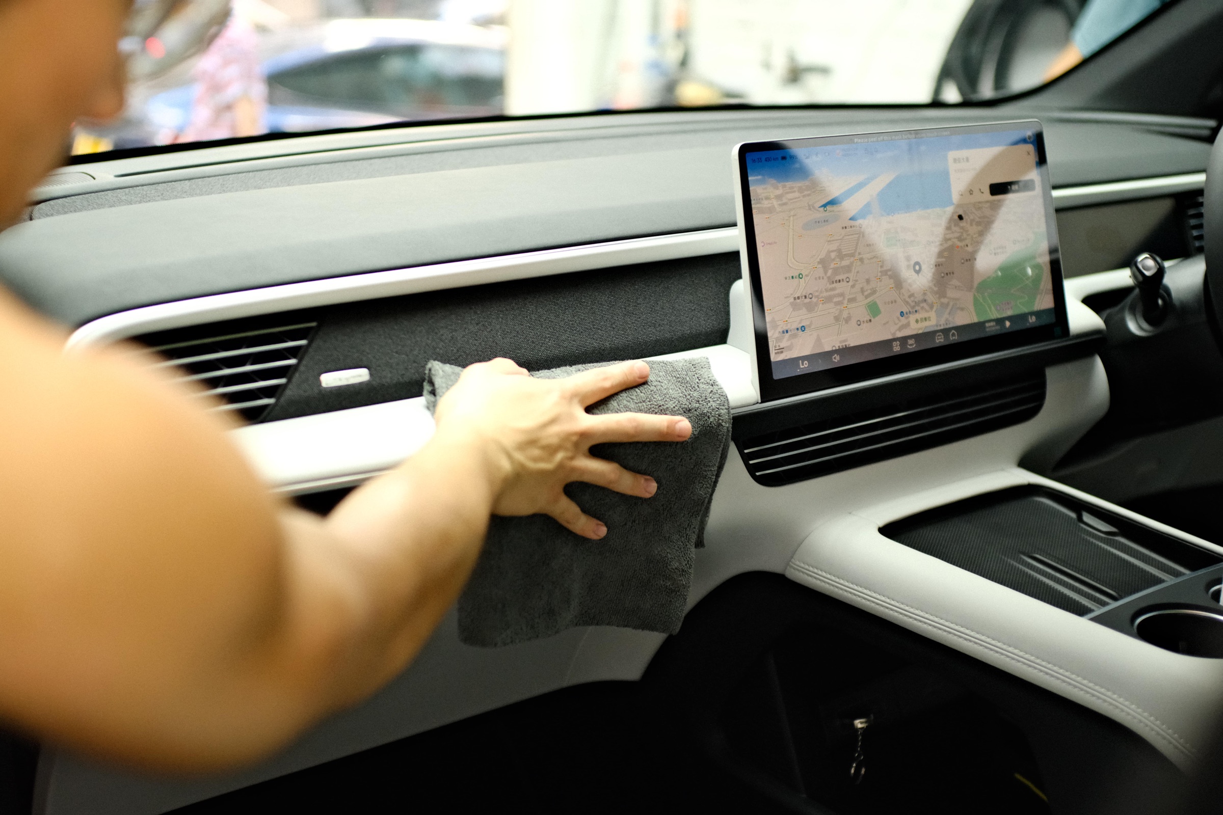 Interior dashboard being wiped by hand